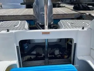 Slide: The Image of 2017 Monterey 197 BR Blackfin boat engine compartment and outboard motor at dock. - 10