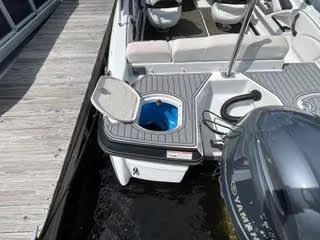 Slide: The Image of 2017 Monterey 197 BR Blackfin boat docked, featuring open storage compartment and Yamaha outboard motor. - 14