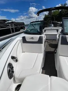 Slide: The Image of 2017 Monterey 197 BR Blackfin boat interior with white seating and blue sky background. - 25