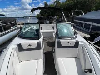 Slide: The Image of 2017 Monterey 197 BR Blackfin boat docked, open bow seating, lake background. - 27