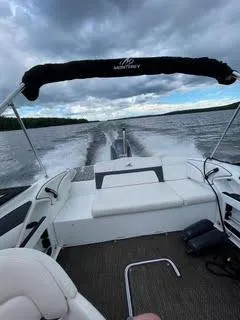 Slide: The Image of 2017 Monterey 197 BR Blackfin boat cruising on a lake under cloudy skies. - 32