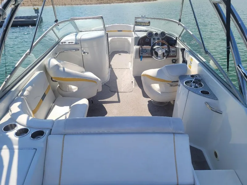 Slide: The Image of 2007 Formula 240 BR boat interior with white seating and steering console. - 11