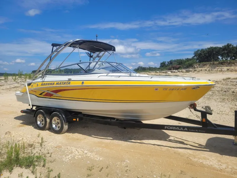 Slide: The Image of 2007 Formula 240 BR yellow boat on trailer in sandy area. - 15