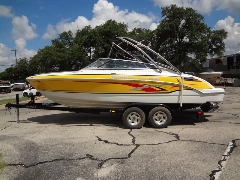 Slide: The Image of 2007 Formula 240 BR boat on a trailer, yellow and white with red accents. - 18