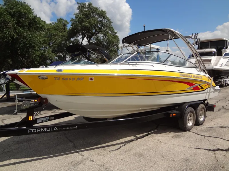 Slide: The Image of 2007 Formula 240 BR yellow speedboat on trailer, parked outdoors. - 19