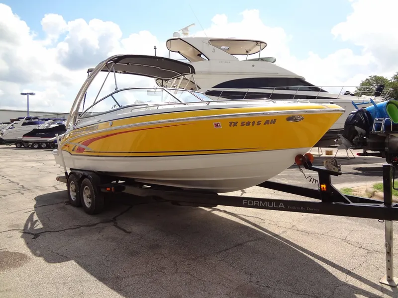 Slide: The Image of 2007 Formula 240 BR yellow speedboat on trailer in marina. - 21