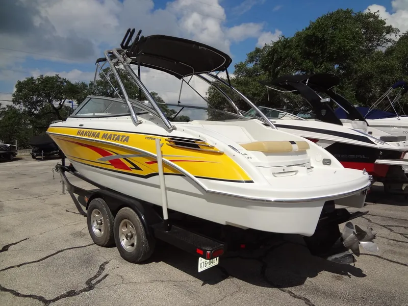Slide: The Image of 2007 Formula 240 BR boat with yellow graphics on a trailer. - 24