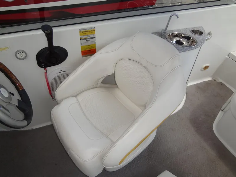 Slide: The Image of Captain's seat of a 2007 Formula 240 BR boat with steering wheel and sink. - 34
