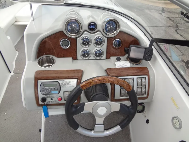 Slide: The Image of 2007 Formula 240 BR boat dashboard with steering wheel, gauges, and controls. - 35