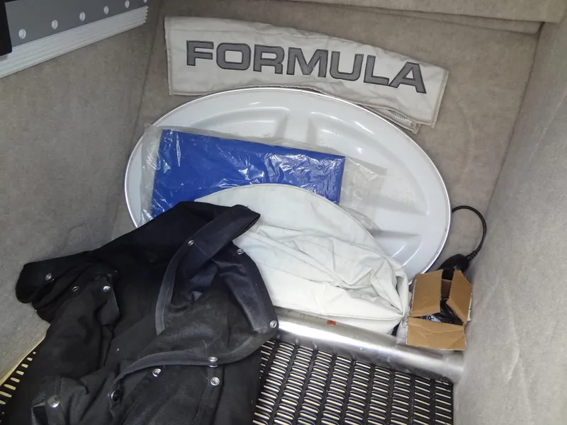 Slide: The Image of Storage compartment of a 2007 Formula 240 BR boat with accessories and cover. - 43