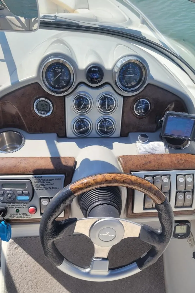 Slide: The Image of 2007 Formula 240 BR boat dashboard with steering wheel and control gauges. - 7