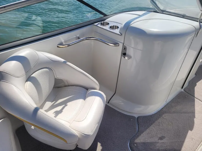 Slide: The Image of 2007 Formula 240 BR boat interior with white seating and cup holders. - 9