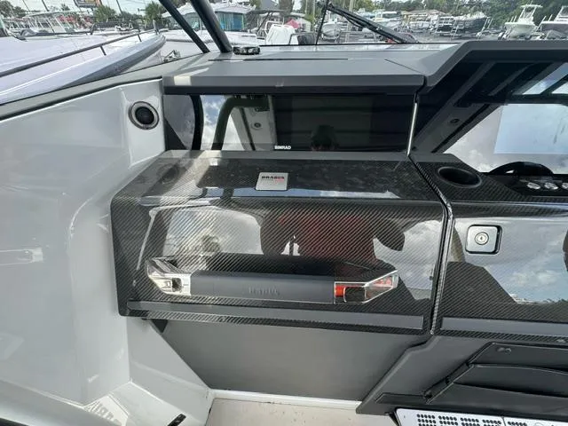 Slide: The Image of 2024 BRABUS Shadow 1000 ST dashboard with sleek carbon fiber finish and modern controls. - 12