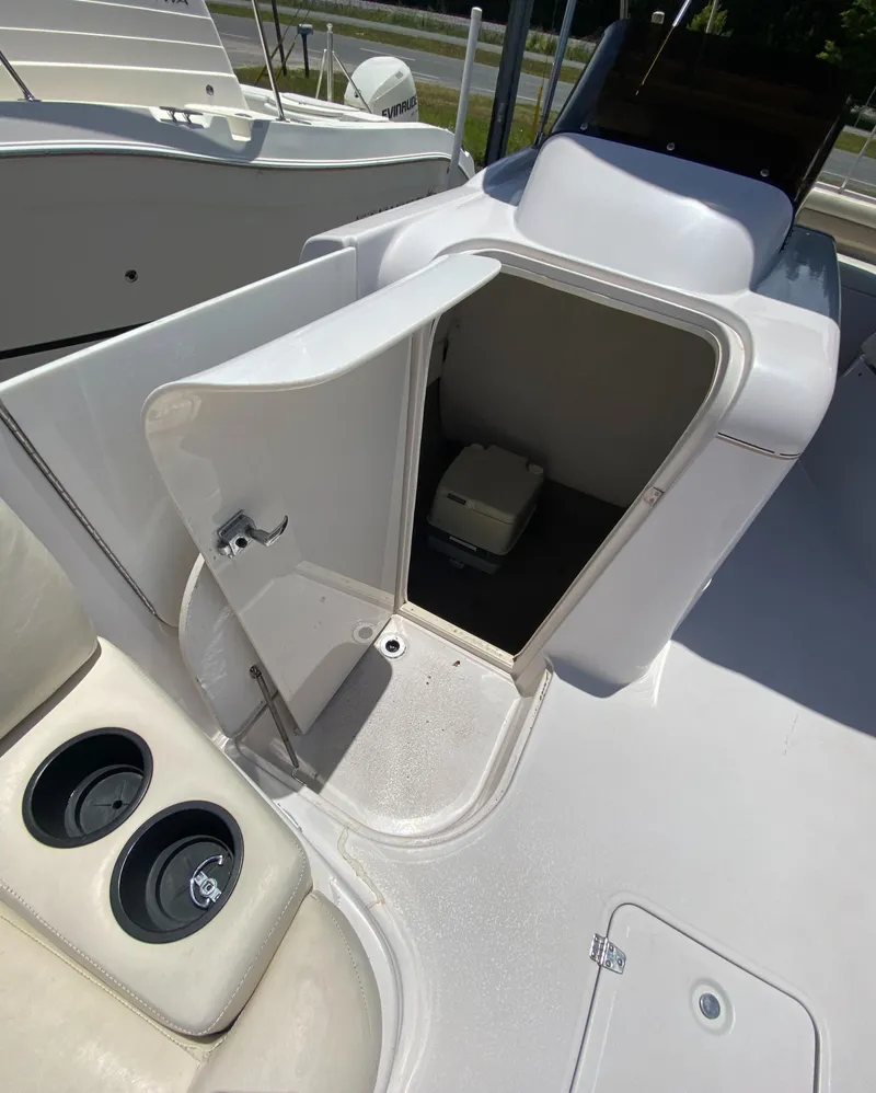 Slide: The Image of 1997 Chaparral 250 Sunseta boat interior with open storage compartment. - 11