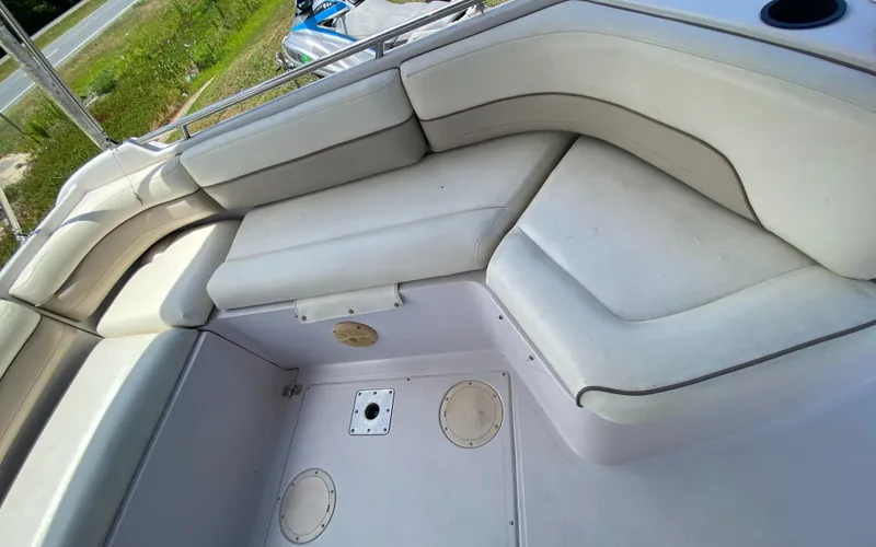 Slide: The Image of 1997 Chaparral 250 Sunseta boat interior with white cushioned seating. - 16