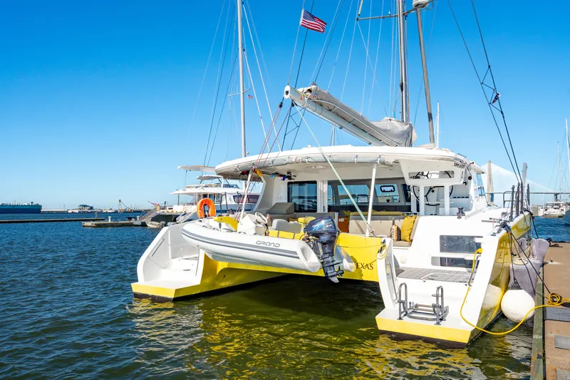 Slide: The Image of Yellow Balance 442 catamaran docked at marina, 2022 model, with clear blue sky. - 10