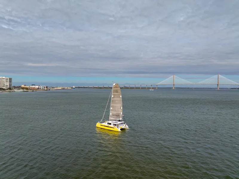 Slide: The Image of Yellow sailboat on open water near a bridge, Balance 442 model, 2022. - 104