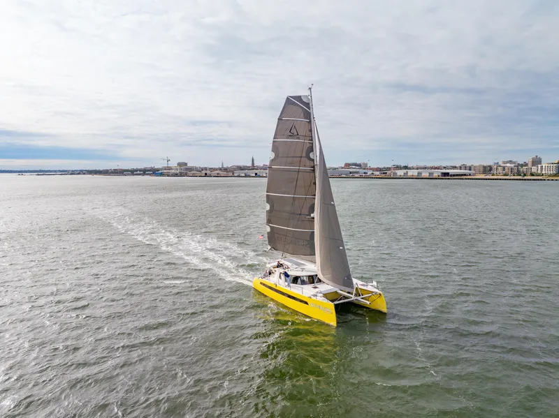 Slide: The Image of Yellow Balance 442 catamaran sailing on open water, 2022 model. - 117