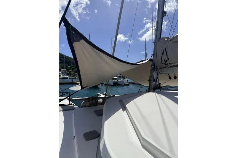 Slide: The Image of Sailboat Balance 442 (2022) with sails up, docked in a sunny marina. - 119