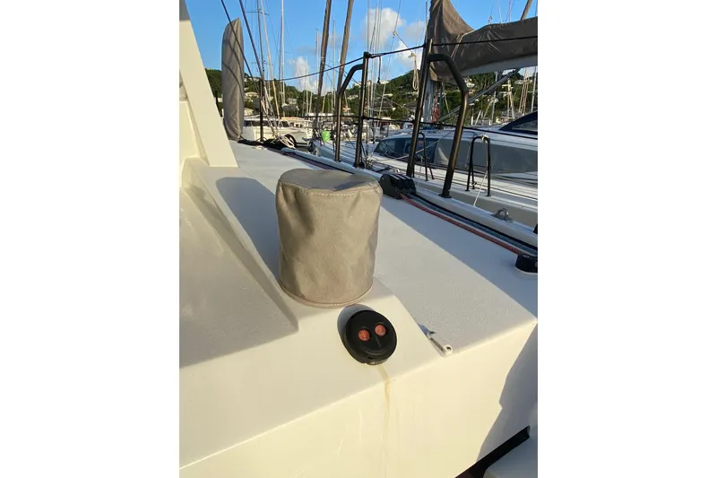 Slide: The Image of Sailboat deck of 2022 Balance 442, featuring covered equipment and marina view. - 122