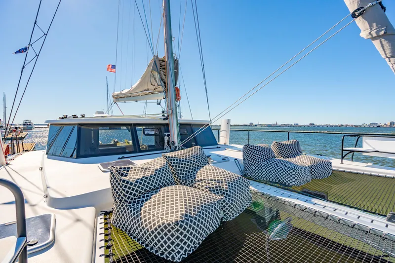 Slide: The Image of Luxury Balance 442 catamaran with cushioned seating, sailing on a sunny day in 2022. - 15