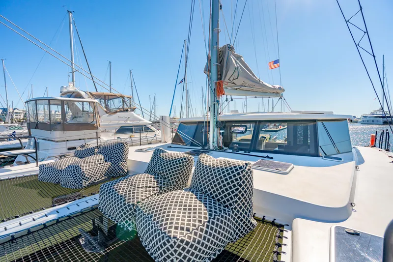 Slide: The Image of 2022 Balance 442 catamaran with patterned seating, docked in a sunny marina. - 17