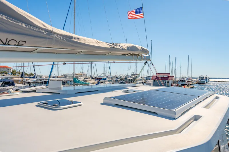 Slide: The Image of Sailboat Balance 442 (2022) with solar panel, docked in marina under clear blue sky. - 21