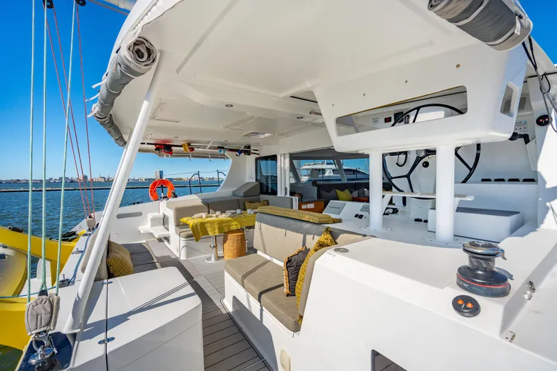 Slide: The Image of Spacious deck of 2022 Balance 442 catamaran with modern seating and ocean view. - 22