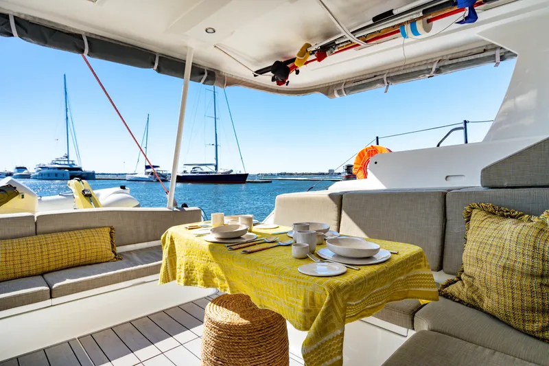 Slide: The Image of Luxurious Balance 442 yacht interior with dining setup, overlooking marina, 2022 model. - 24