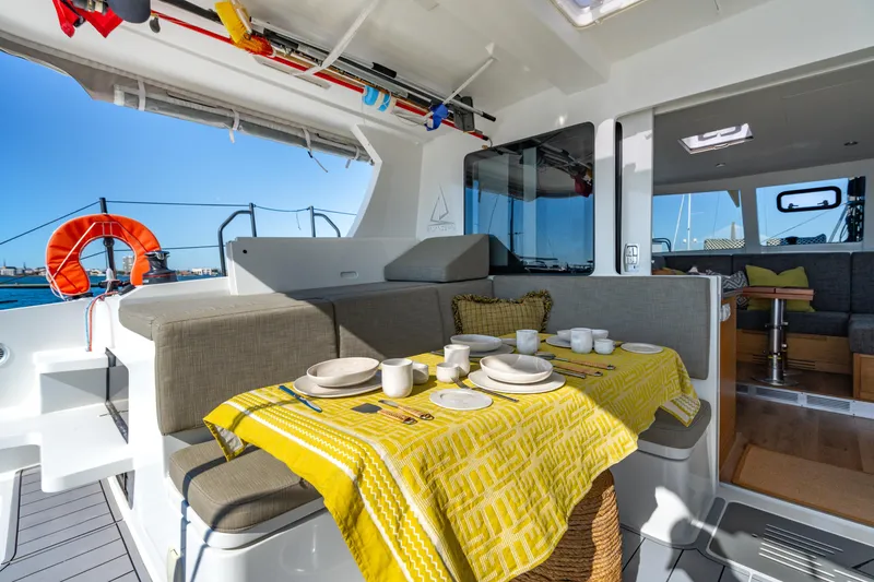 Slide: The Image of Luxurious Balance 442 yacht interior with dining area, yellow tablecloth, and ocean view, 2022 model. - 26