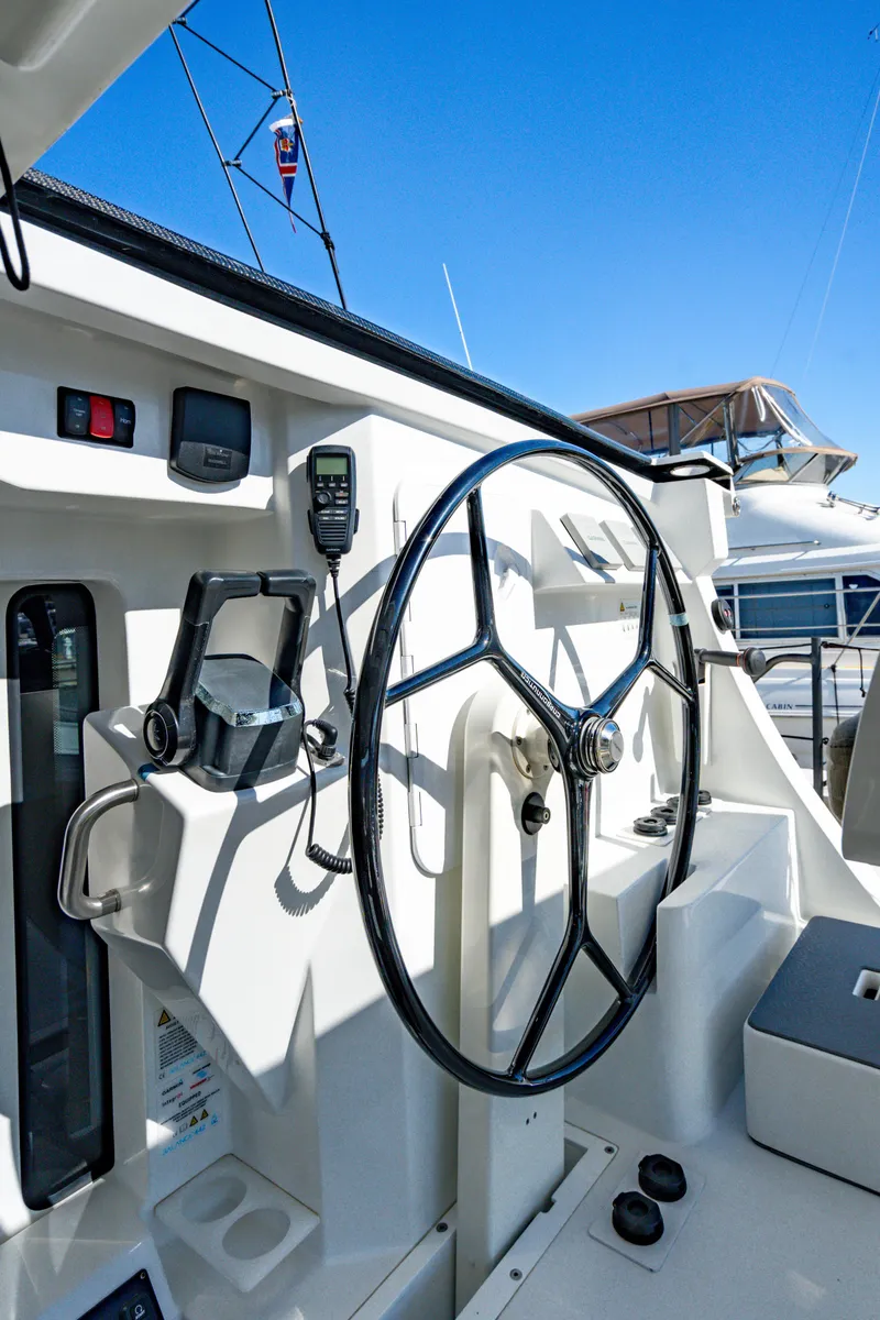 Slide: The Image of Steering wheel of 2022 Balance 442 yacht under clear blue sky. - 29