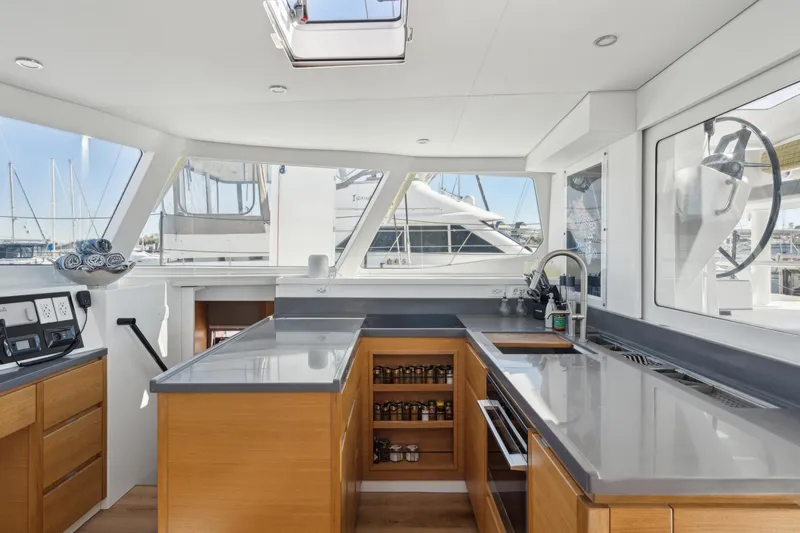 Slide: The Image of Modern yacht kitchen interior with sleek countertops and wooden cabinetry, Balance 442 model, 2022. - 33