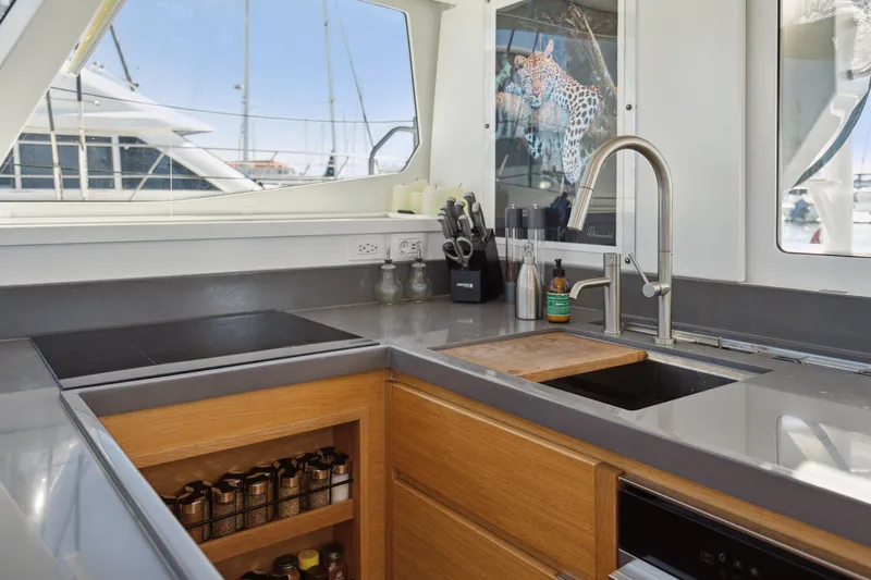 Slide: The Image of Modern yacht kitchen with sleek countertops, wooden cabinets, and stainless steel sink. Balance 442, 2022 model. - 40