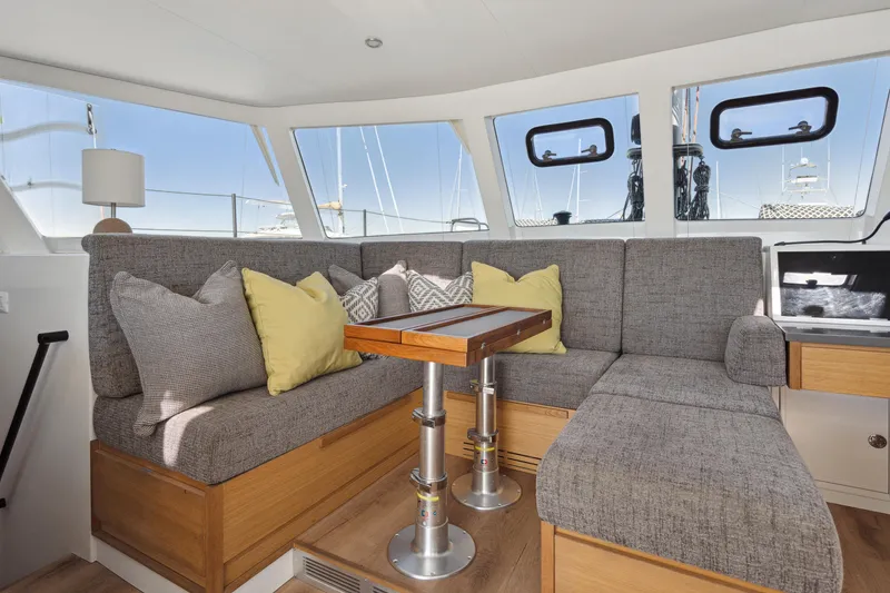 Slide: The Image of Modern yacht interior with gray seating, yellow pillows, and a wooden table. Balance 442, 2022 model. - 44