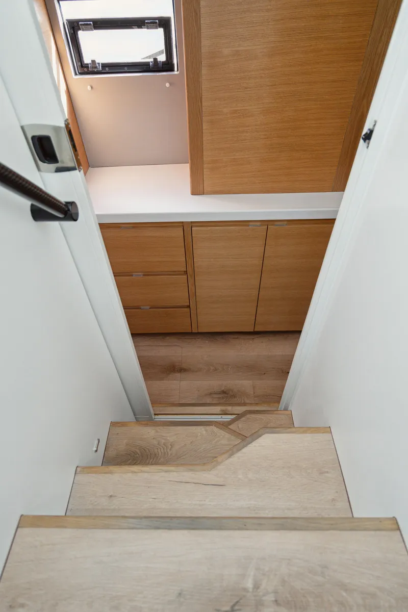 Slide: The Image of Wooden stairs leading to a modern interior with cabinets, Balance 442, 2022 model. - 46