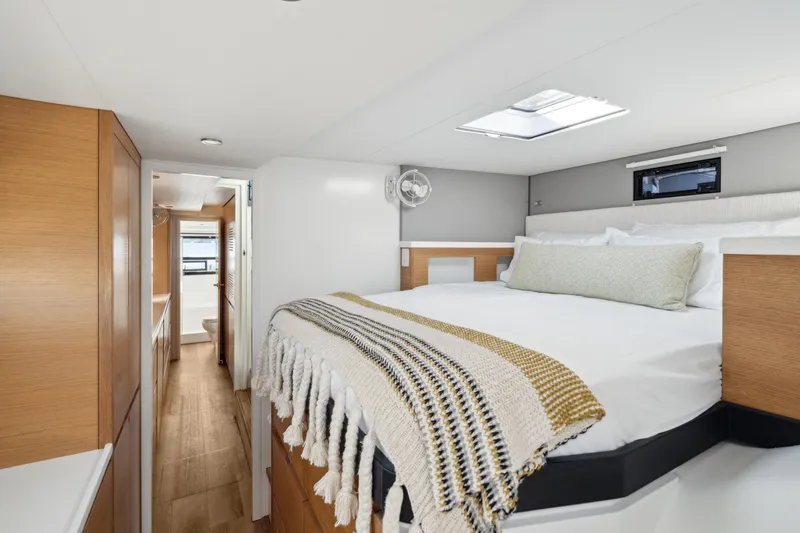 Slide: The Image of Modern bedroom interior in 2022 Balance 442 yacht, featuring cozy bed and wooden accents. - 49