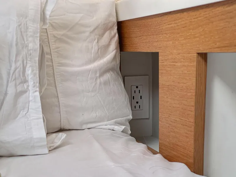 Slide: The Image of Power outlet behind bed with wooden frame, Balance 442 model, 2022. - 50