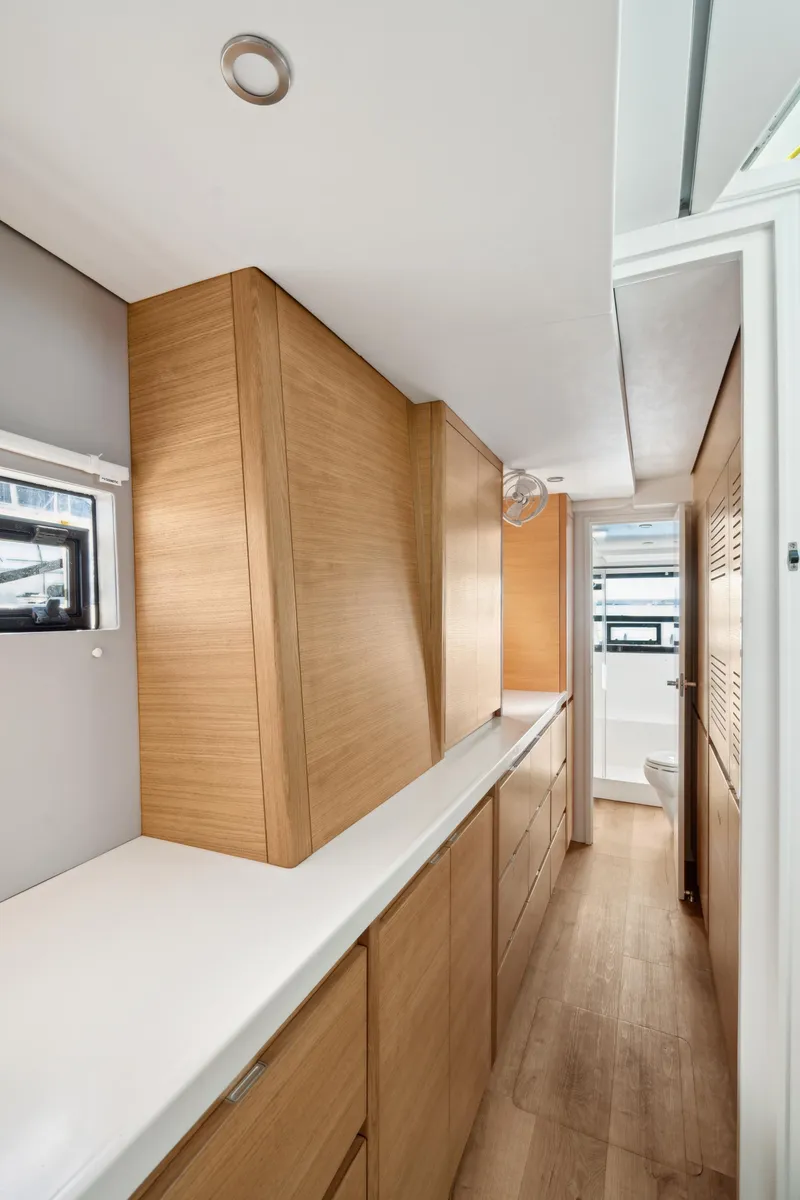 Slide: The Image of Modern interior of 2022 Balance 442 yacht with sleek wood cabinetry and bright lighting. - 52