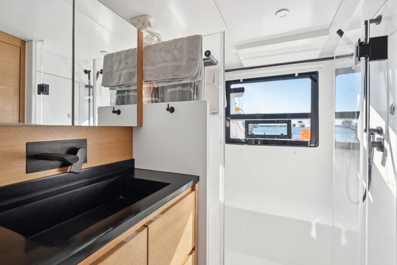 Slide: The Image of Modern bathroom in 2022 Balance 442 yacht with sleek black sink and wooden cabinetry. - 53