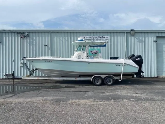 Slide: The Image of 2008 Everglades 290 CC boat on a trailer in front of a warehouse. - 0