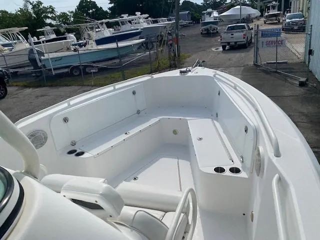 Slide: The Image of 2008 Everglades 290 CC boat interior with seating and cup holders in a marina. - 10
