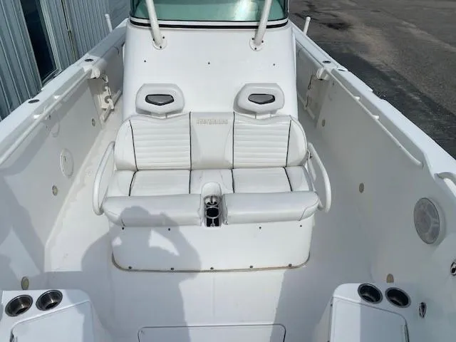 Slide: The Image of 2008 Everglades 290 CC boat interior with white seating and cup holders. - 11