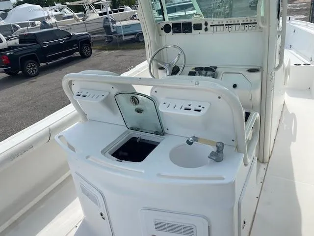 Slide: The Image of 2008 Everglades 290 CC center console boat interior with helm and sink. - 3