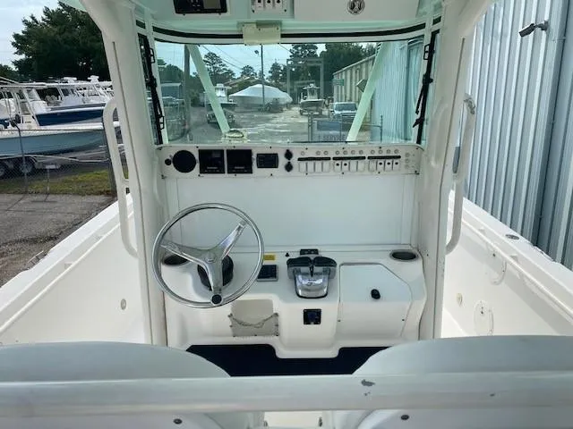 Slide: The Image of 2008 Everglades 290 CC boat cockpit with steering wheel and control panel. - 4