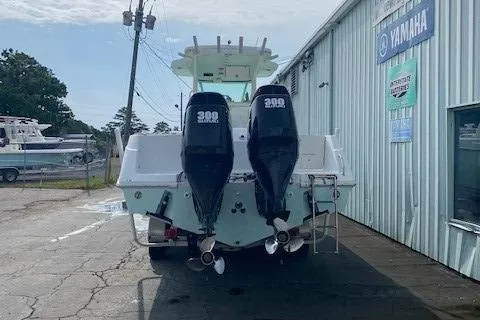 Slide: The Image of 2008 Everglades 290 CC boat with twin 300 HP engines at a marina. - 7