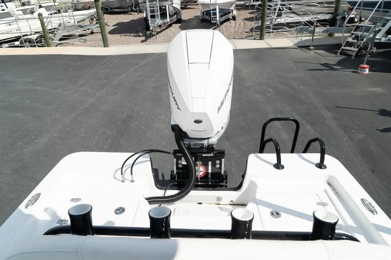 Slide: The Image of 2025 Blazer 2220 Fisherman boat with outboard motor in a marina. - 12