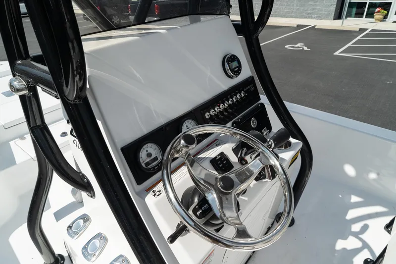 Slide: The Image of 2025 Blazer 2220 Fisherman boat console with steering wheel and control panel. - 22