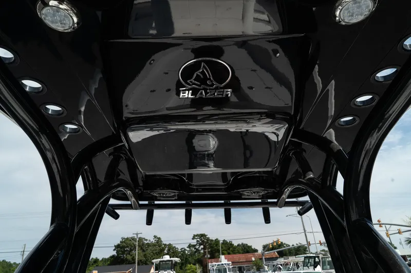Slide: The Image of 2025 Blazer 2220 Fisherman boat's sleek black T-top with integrated lighting. - 26
