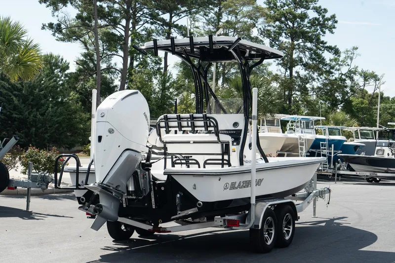 Slide: The Image of 2025 Blazer 2220 Fisherman boat on a trailer in a marina. - 4