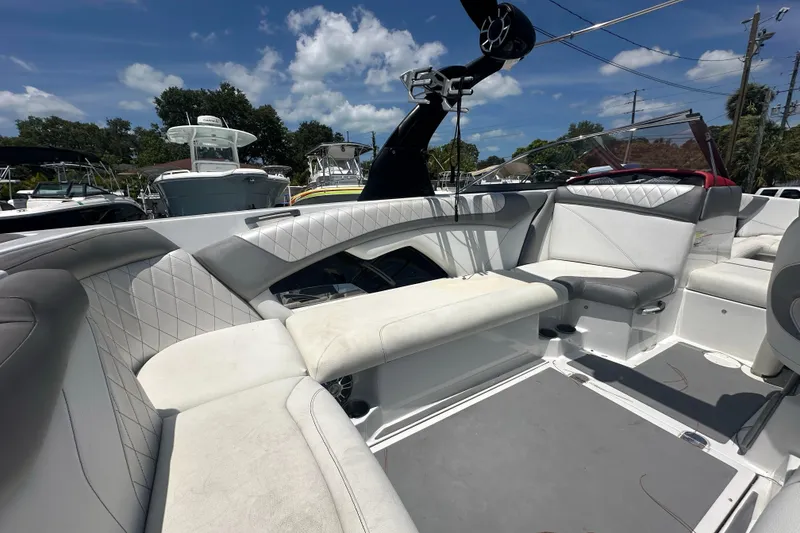 Slide: The Image of 2015 Tigé Z3 boat interior with white and gray seating under a sunny sky. - 10